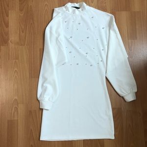 White high neck dress with pearl embellishments
